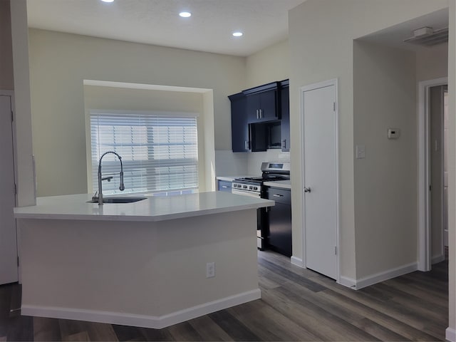 kitchen featuring gas range, kitchen peninsula, sink, and dark hardwood / wood-style flooring