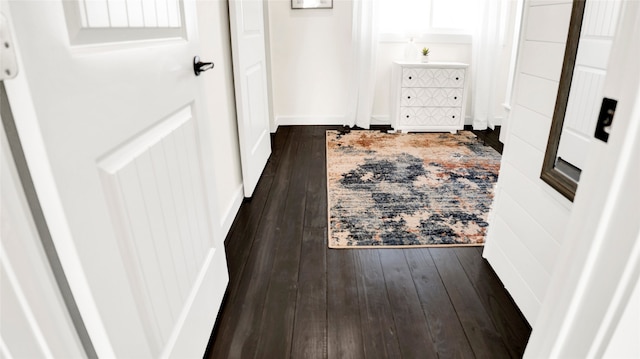 corridor with dark hardwood / wood-style floors