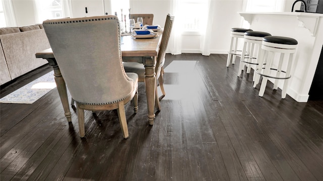 dining space with dark hardwood / wood-style floors