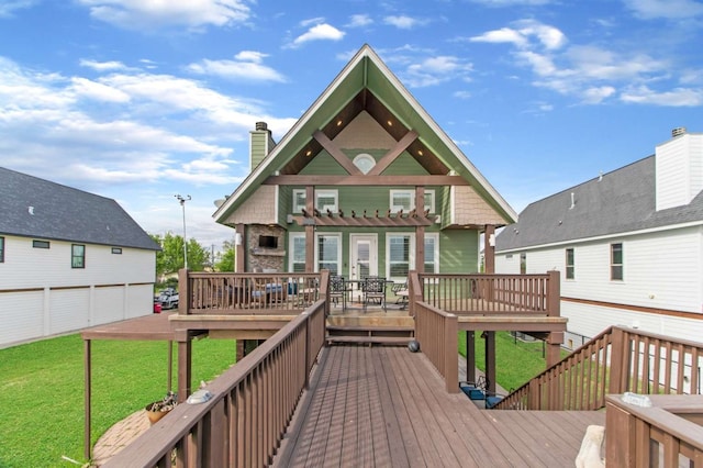 back of house with a garage, a deck, and a yard