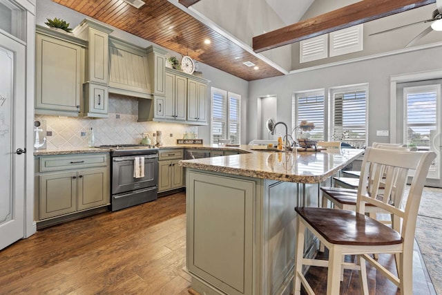 kitchen with wood ceiling, light stone counters, dark wood-type flooring, a center island with sink, and stainless steel range