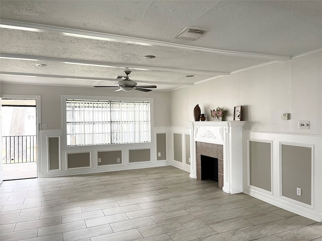 unfurnished living room featuring a textured ceiling, a fireplace, ceiling fan, and a wealth of natural light