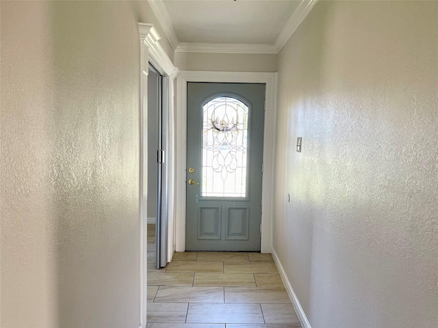 doorway to outside with baseboards and ornamental molding