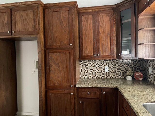 kitchen featuring light stone countertops and decorative backsplash