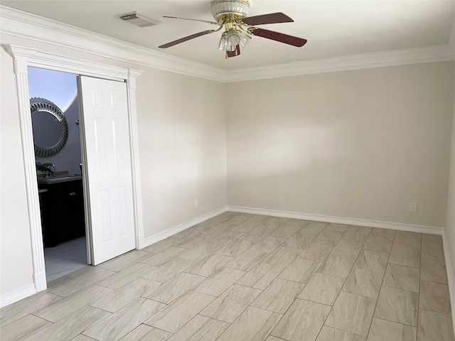 empty room featuring ceiling fan, visible vents, a sink, baseboards, and ornamental molding