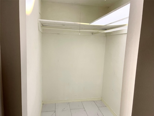 spacious closet featuring marble finish floor