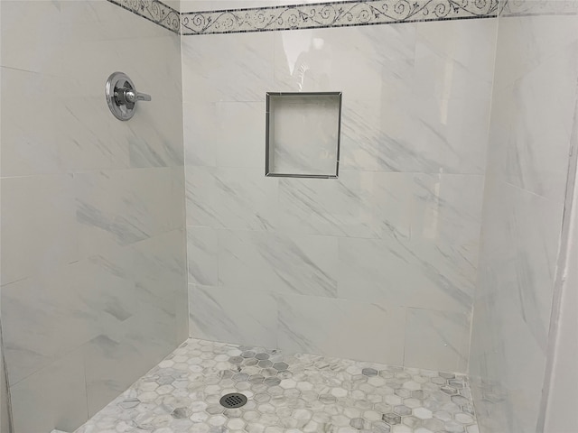 bathroom featuring tiled shower