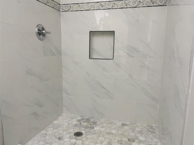 full bath with a tile shower