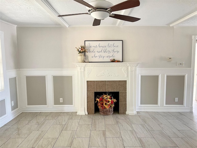 unfurnished living room featuring a fireplace, a ceiling fan, a decorative wall, and a textured ceiling