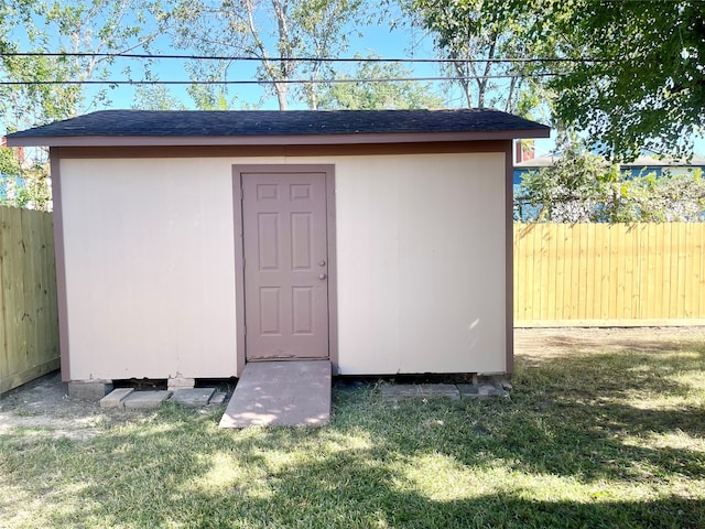 view of outdoor structure featuring a lawn