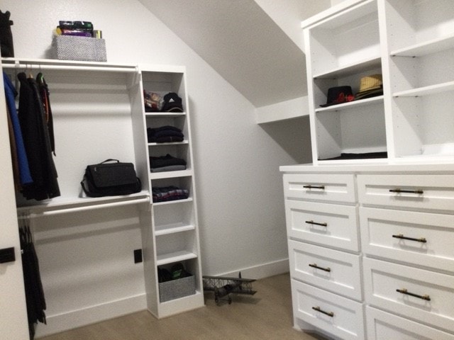 walk in closet featuring vaulted ceiling