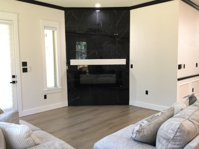 living room with ornamental molding and wood-type flooring