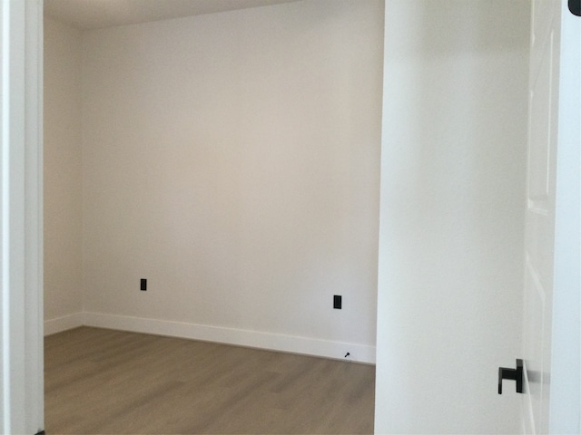 unfurnished room featuring hardwood / wood-style flooring