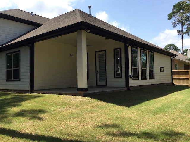 back of house featuring a patio and a lawn