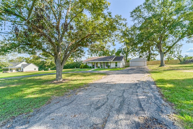 view of front of property with an outbuilding and a front yard