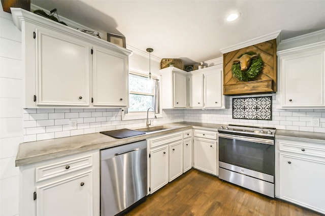 kitchen featuring stainless steel appliances, hanging light fixtures, and white cabinetry