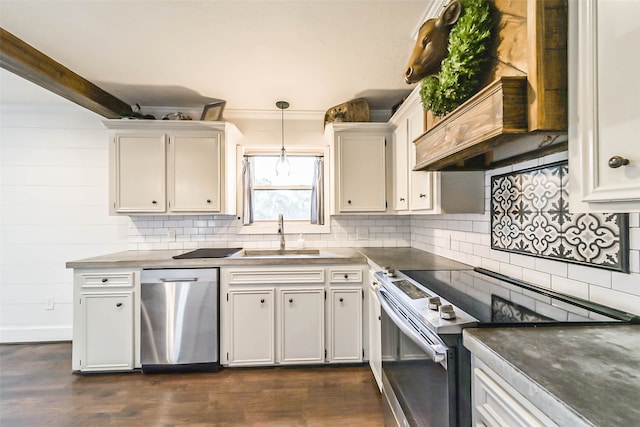 kitchen featuring dark wood-type flooring, sink, white cabinets, stainless steel appliances, and decorative light fixtures