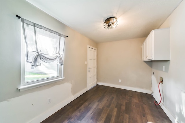 laundry area featuring cabinets, hookup for a washing machine, and dark wood-type flooring