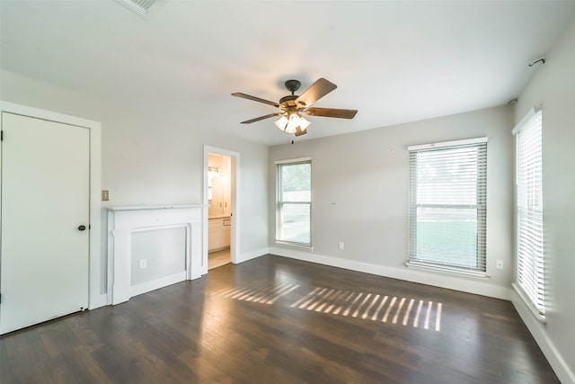 empty room with ceiling fan and dark wood-type flooring