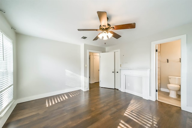 unfurnished bedroom featuring ceiling fan, connected bathroom, and dark hardwood / wood-style flooring