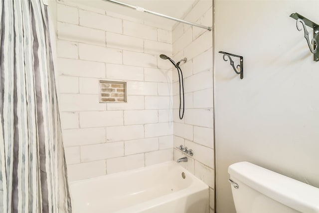 bathroom featuring shower / tub combo and toilet