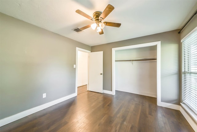 unfurnished bedroom featuring a closet, ceiling fan, and dark wood-type flooring