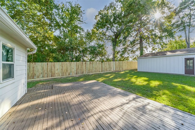 deck featuring a lawn and an outbuilding