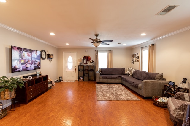 living room with ceiling fan, crown molding, and hardwood / wood-style floors