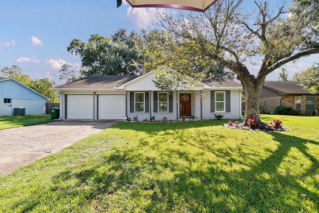 single story home featuring a front yard, central AC unit, and a garage