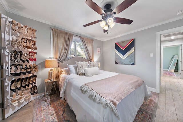 bedroom featuring ornamental molding, hardwood / wood-style flooring, and ceiling fan