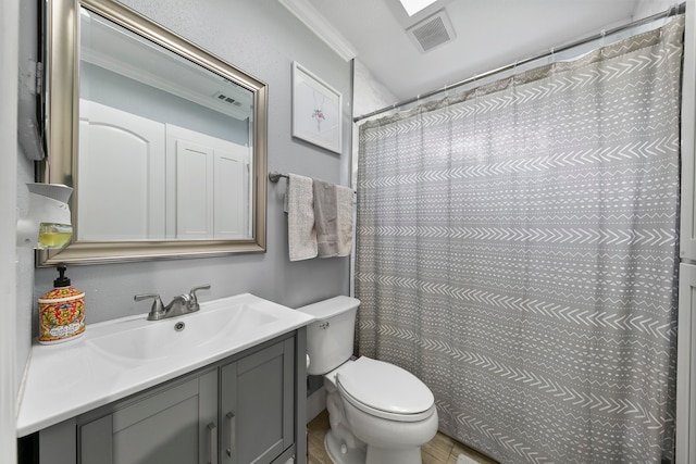 bathroom with vanity, crown molding, a shower with curtain, and toilet