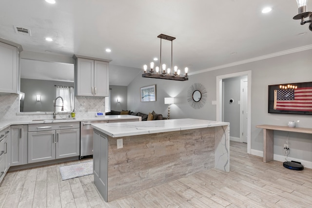 kitchen with stainless steel dishwasher, a kitchen island, light hardwood / wood-style flooring, and gray cabinets