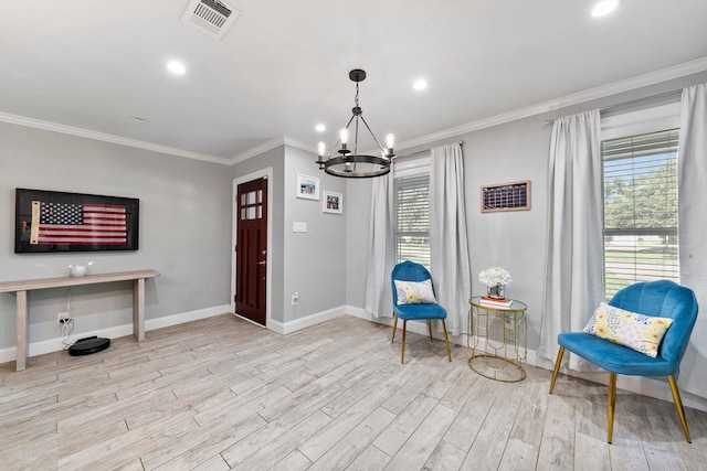 sitting room with an inviting chandelier, ornamental molding, and light hardwood / wood-style floors