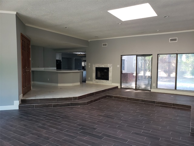 unfurnished living room with ornamental molding, a high end fireplace, a textured ceiling, and dark hardwood / wood-style flooring