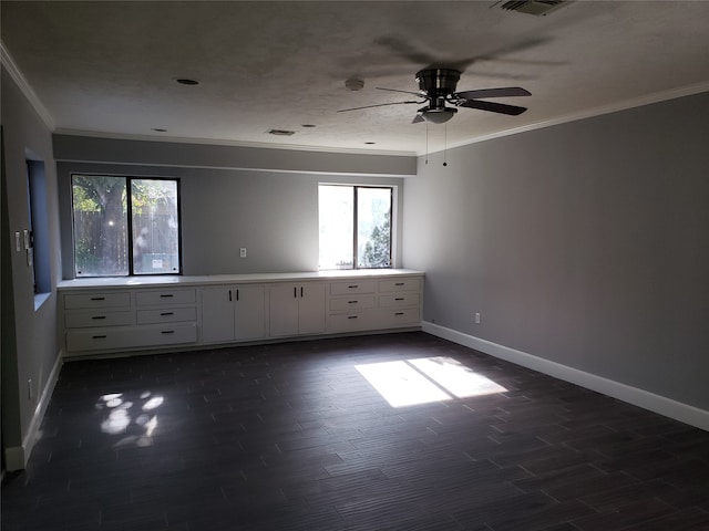 empty room with ornamental molding, ceiling fan, and dark hardwood / wood-style floors