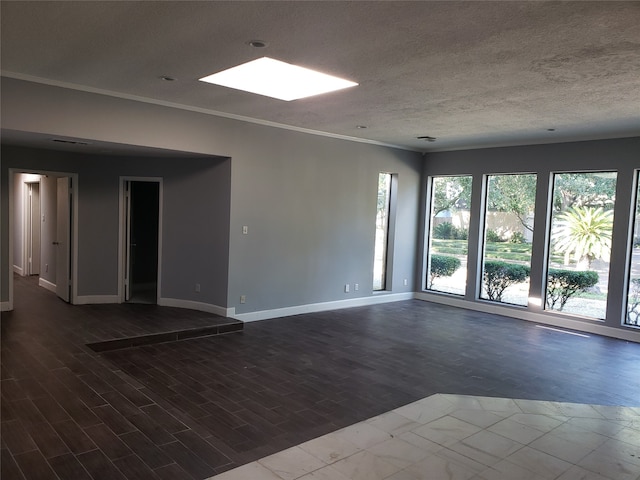 spare room featuring a textured ceiling, crown molding, and hardwood / wood-style floors