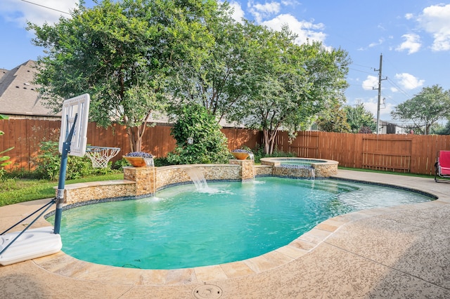 view of swimming pool featuring pool water feature, a patio, and an in ground hot tub