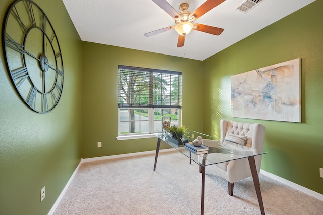 carpeted office space featuring ceiling fan