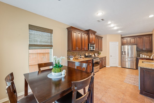 dining room with sink and light tile patterned floors