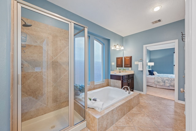 bathroom featuring independent shower and bath, vanity, and tile patterned floors