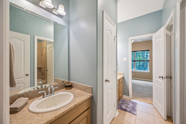 bathroom with a shower with curtain, vanity, and tile patterned floors