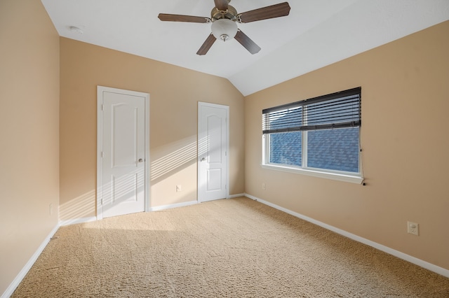 unfurnished bedroom featuring lofted ceiling, carpet flooring, and ceiling fan