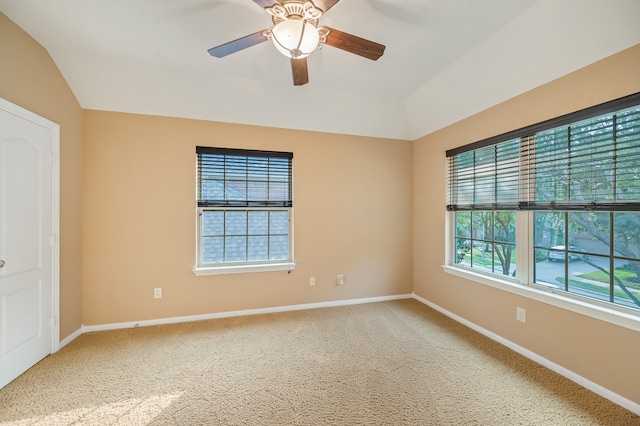 carpeted empty room featuring lofted ceiling and ceiling fan