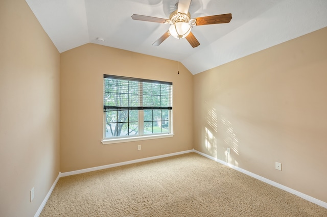 carpeted spare room featuring ceiling fan and vaulted ceiling