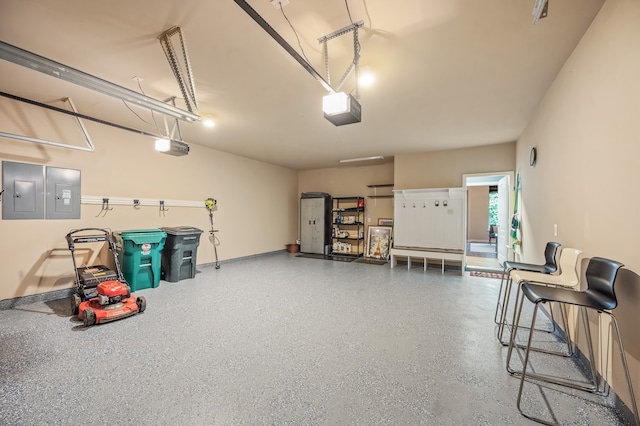 garage with a garage door opener and electric panel