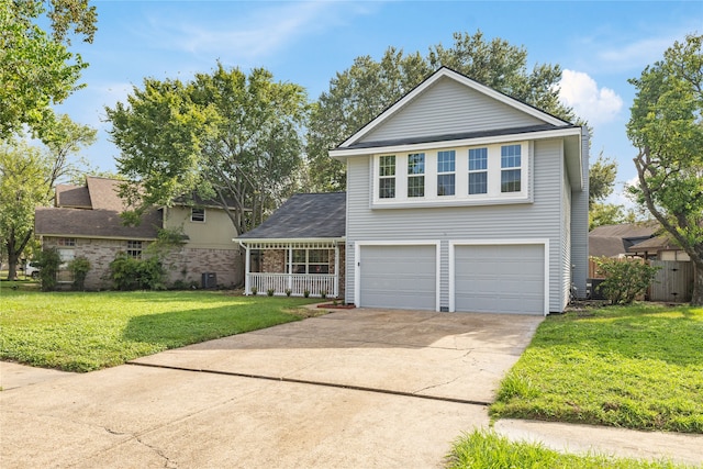 front facade featuring central AC unit, a garage, a front lawn, and covered porch