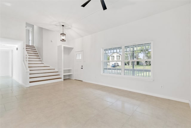 unfurnished living room with ceiling fan and light tile patterned flooring