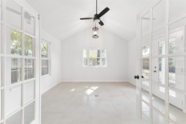 tiled spare room featuring ceiling fan, plenty of natural light, and french doors