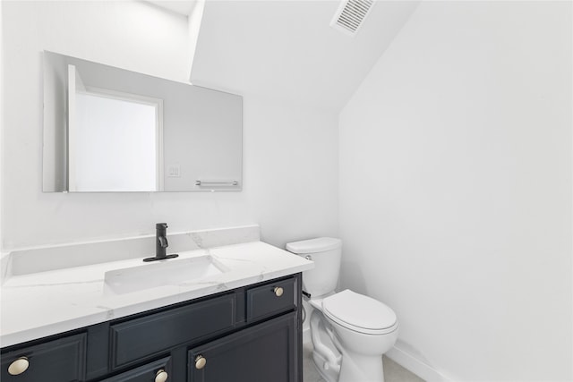 bathroom featuring vaulted ceiling, vanity, and toilet