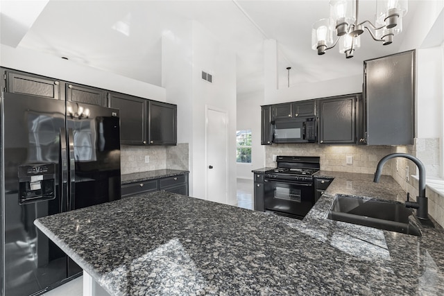 kitchen with hanging light fixtures, sink, high vaulted ceiling, black appliances, and a notable chandelier